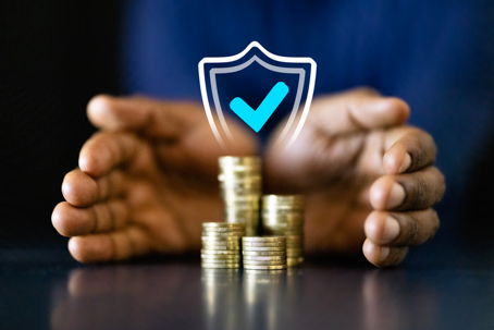 Hands shielding coins