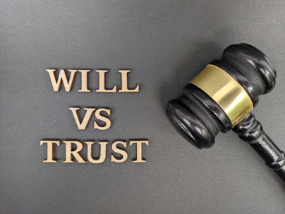 Wills Vs Trusts spelled out with gavel next to it