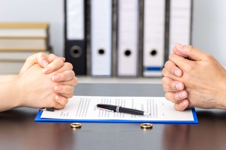 two people folding hands with contract